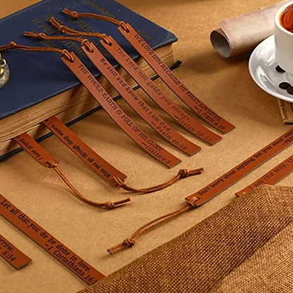 Several brown tasseled bookmarks arranged beside a blue book.