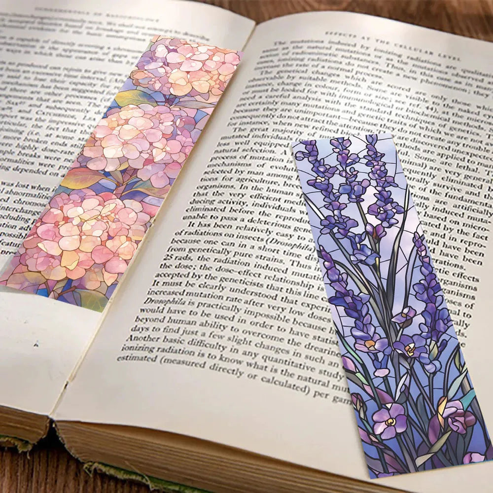 Pink and purple floral bookmarks marking pages in an open Bible
